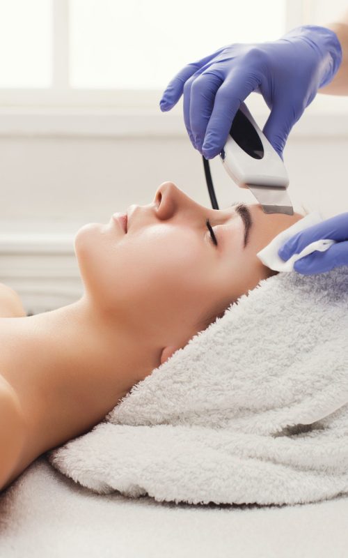 woman-getting-facial-treatment-at-beauty-salon